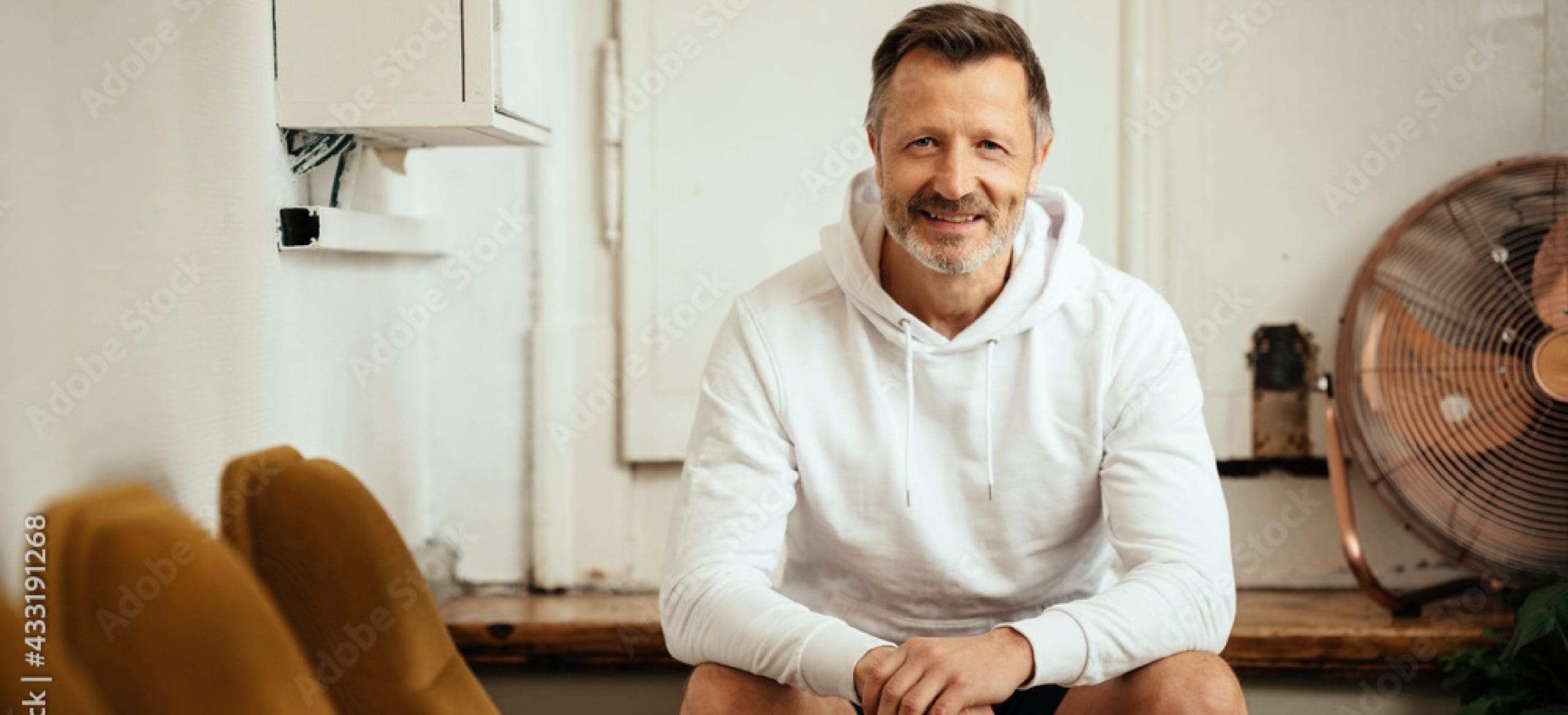 Man sitting on a bench inside a building